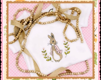 Sweet Easter design!  Peter Rabbit's sister, Flopsy, on an adorable puffed sleeve, white or pink onesie!