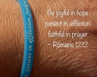 Romans 12 glow-in-the-dark wristbands read - Be joyful in hope, patient in affliction, faithful in prayer  ~ Romans 12:12