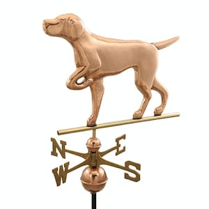 May include: Copper weather vane featuring a standing dog with a raised paw. The vane is mounted on a gold metal rod with a compass rose and directional arrows.