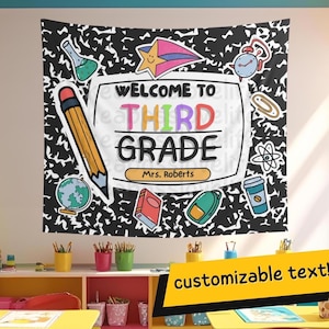 May include: A large classroom banner with the text "WELCOME TO THIRD GRADE" in colorful letters. The banner features school-themed illustrations like a pencil, globe, and book, set against a black and white background.