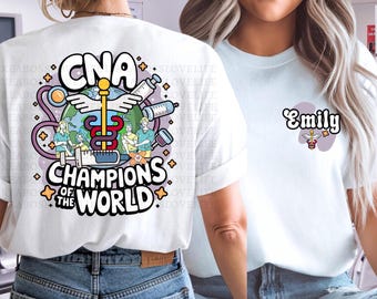 May include: Two white t-shirts, one with a colorful graphic of a medical caduceus and the text "CNA Champions of the World" and the other with the name "Emily" in a stylized font.