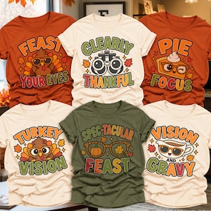 May include: Six t-shirts in orange, cream, and olive green featuring Thanksgiving-themed graphics and text. Designs include a turkey with sunglasses, an optometrist phoropter, a slice of pie, and glasses with pumpkin and leaf motifs.