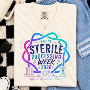 May include: An ivory t-shirt featuring a colorful gradient graphic with the text Happy Sterile Processing Week 2026. The design includes illustrations of medical instruments, a sterilization unit, and the words Precision, Patient Safety, Excellence.