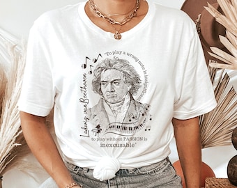 May include: White t-shirt with a black and white illustration of Ludwig van Beethoven. The quote "To play a wrong note is insignificant to play without PASSION is inexcusable" is printed on the shirt.