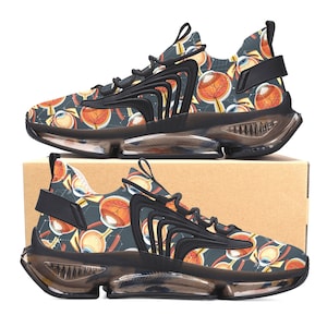 May include: A pair of black sneakers with a transparent sole. The sneakers have a dark blue and black patterned design featuring anatomical eye illustrations.