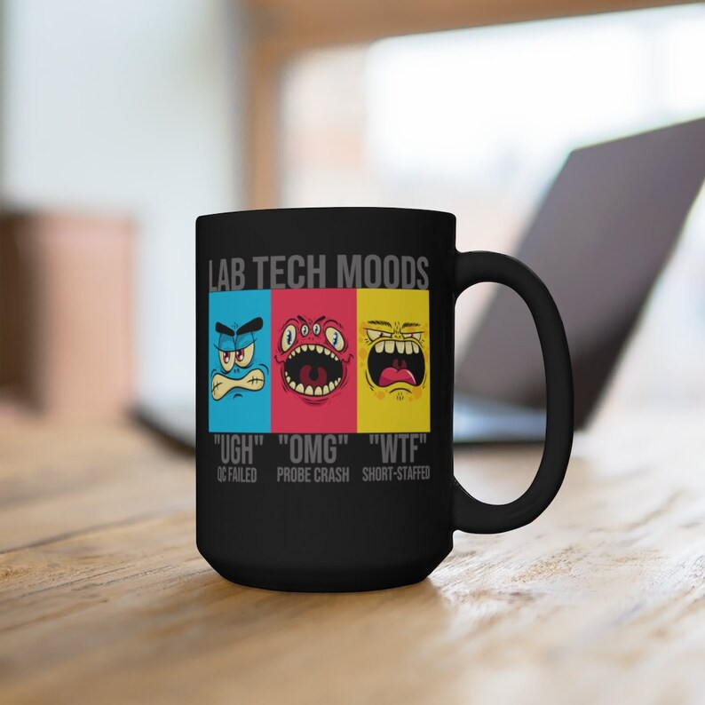 May include: Black ceramic mug with the text "LAB TECH MOODS" and three cartoon faces expressing different emotions. Below the faces are the phrases "UGH", "OMG", and "WTF", with related lab scenarios.