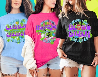 May include: Three t-shirts in Carolina Blue, Heliconia, and Black. Each shirt features a unique graphic with the text "another case" and a medical theme, such as "Clinical Chemist" or "Blood Bank". The designs are in purple, green, and white.