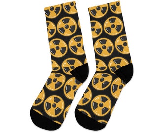 May include: A pair of black socks with a yellow and black radiation symbol pattern.
