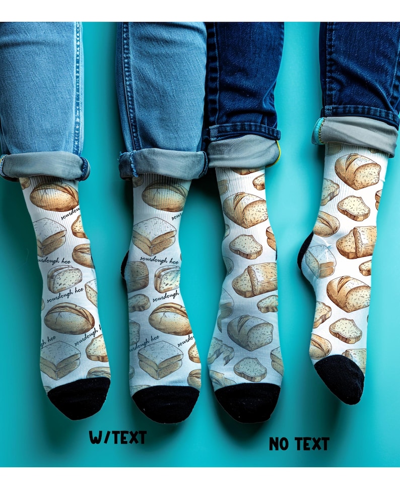 May include: White socks with a sourdough bread pattern. The socks have black heels and toes. The text "sourdough hoo" is printed on the socks. The socks are worn with blue jeans.