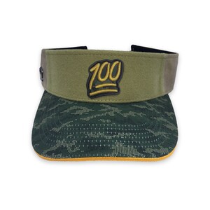 May include: A green and brown camouflage visor with a yellow 100 emoji patch on the front.