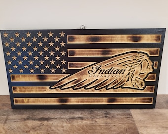 May include: A wooden American flag with a burnt wood finish. The flag features the Indian Motorcycle logo with the words "Indian Motorcycle" in a stylized font.