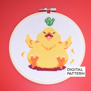 May include: A cross-stitch pattern of a yellow chick with a green leaf on its head. The chick is sitting on a red base and has its wings spread out. The pattern is framed in a wooden hoop. "DIGITAL PATTERN" is printed in the bottom right corner.