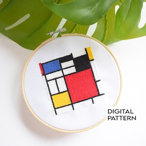 May include: A cross-stitch embroidery in a wooden hoop features a geometric design with red, blue, yellow, black, and white blocks. The text "DIGITAL PATTERN" is visible. The artwork is inspired by the style of Piet Mondrian.