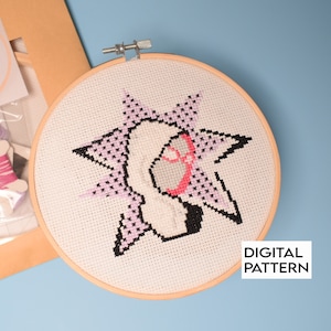 May include: A cross-stitch pattern of a pink and white cartoon character with a starburst design. The pattern is in a wooden embroidery hoop. The text "DIGITAL PATTERN" is visible in the lower right corner of the image.
