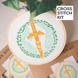 May include: Cross stitch kit featuring a green and yellow design with the text "CROSS STITCH KIT".
