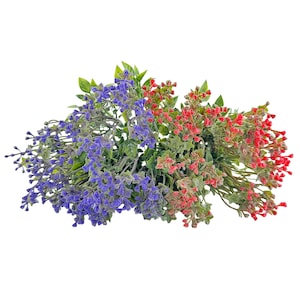 May include: A collection of artificial flowers in shades of purple and red, with green leaves. The flowers are clustered together, creating a full and vibrant display. The image is set against a plain white background.