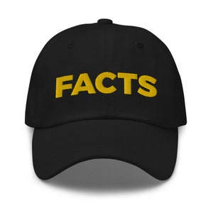 May include: A black baseball cap with a yellow embroidered word "FACTS" on the front.