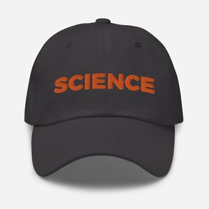 May include: A dark grey baseball cap with an orange embroidered word "SCIENCE" on the front.