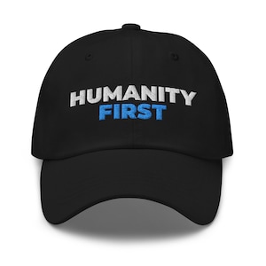 May include: A black baseball cap with white and blue embroidered text that reads "HUMANITY FIRST".