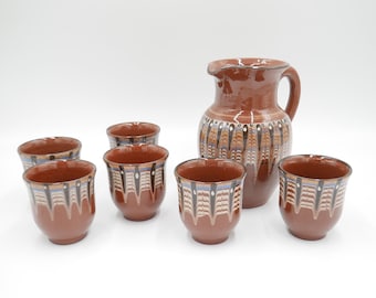 Drip glaze pitcher and six tumblers Troyan folk art Bulgarian pottery