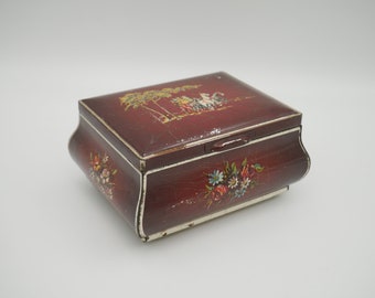 Vintage burgundy metal tin with hinged lid