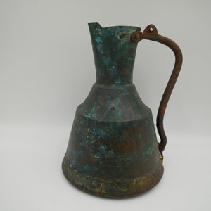 Antique hand hammered copper pitcher