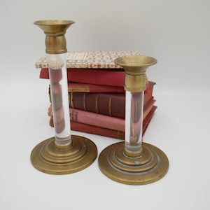 A pair of brass and Lucite candlestick holders