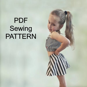 May include: A young girl wearing a black and white striped crop top and matching skirt, paired with black sneakers. The image includes the text "PDF Sewing PATTERN" in large, bold letters.