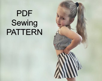 May include: A young girl wearing a black and white striped crop top and matching skirt, paired with black sneakers. The image includes the text "PDF Sewing PATTERN" in large, bold letters.