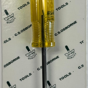 May include: A yellow and black C.S. Osborne No. 405-3/16 caning chisel with a black handle and a barcode label. The label reads "OSBORNE No. 405-3/16 96685 53224 0 1 Ea. CANING CHISEL C.S. OSBORNE & CO. HARRISON, NJ 07029 U.S.A."