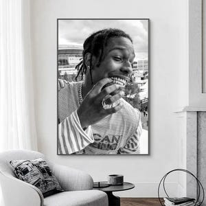 Puede incluir: Foto en blanco y negro de un hombre con una camisa a rayas y una cadena de oro. Est&aacute; sonriendo y tiene una parrilla de oro en los dientes.
