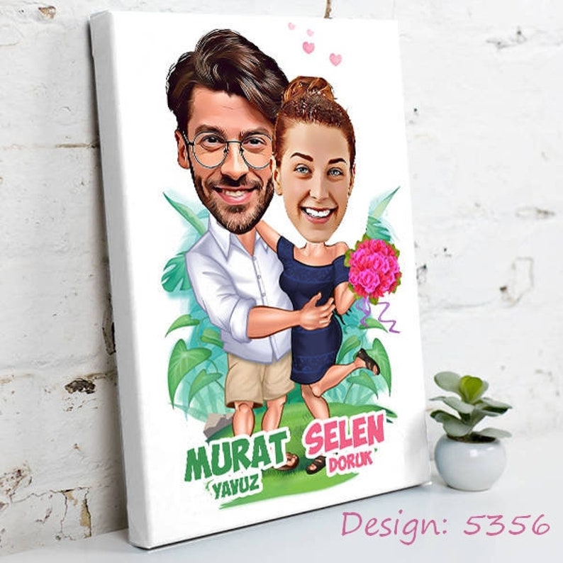 May include: Canvas art print featuring a cartoon couple embracing, with oversized heads and bodies. The man wears glasses, a white shirt, and khaki shorts. The woman wears a navy blue dress and holds pink flowers. Text includes "Murat Yavuz" and "Selen Doruk". Design number 5356.