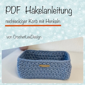 Op de afbeelding: Een blauwe rechthoekige gehaakte mand met handvatten. De mand is gemaakt met een sterrensteekpatroon. De tekst "CrochetLeeDesign" staat op een label dat aan de mand is bevestigd.