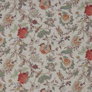 May include: Cream-coloured floral fabric featuring a repeating pattern of large red, orange, and pink flowers. Green leaves and smaller blossoms are interspersed with winding branches, creating a detailed botanical design.