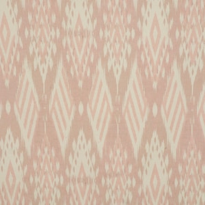 May include: A pink and beige fabric with a repeating geometric pattern. The pattern is made up of diamonds and swirls.