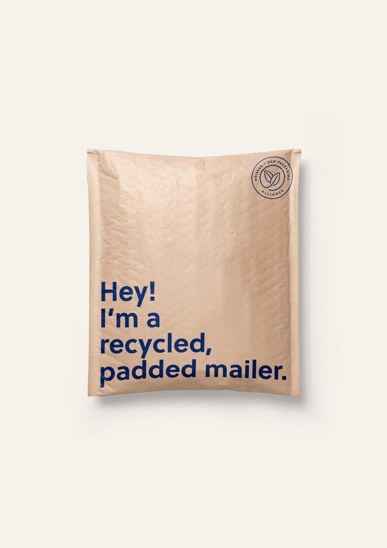May include: A light tan, rectangular padded mailer with a textured surface. The front features dark blue text that reads, "Hey! I'm a recycled, padded mailer." In the top right corner, there is a circular logo with the text "noissue eco packaging alliance."