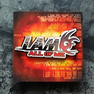 May include: A black and red enamel pin with the words "I AM ALL OF ME" in white lettering. The pin features a stylized flame design.