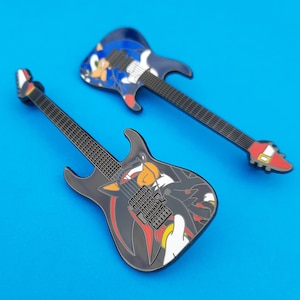 Enamel pin badge based on the ESP Sonic-II and Shadow-II guitars.