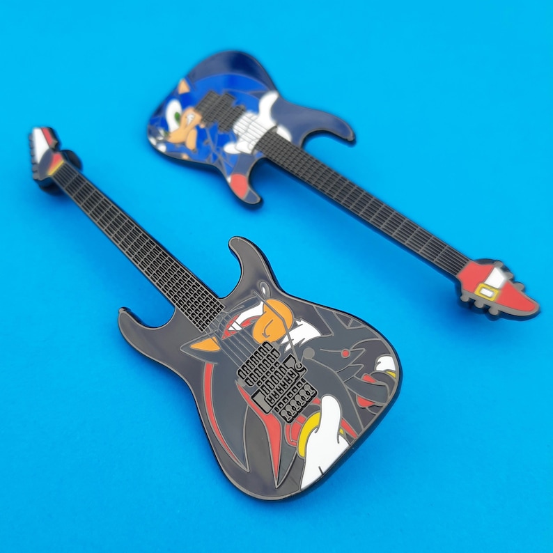 Enamel pin badge based on the ESP Sonic-II and Shadow-II guitars.