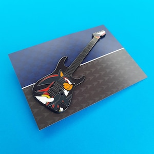 Enamel pin badge based on the ESP Sonic-II guitars, shown here on the backing card how if you purchase the Shadow variant individually.