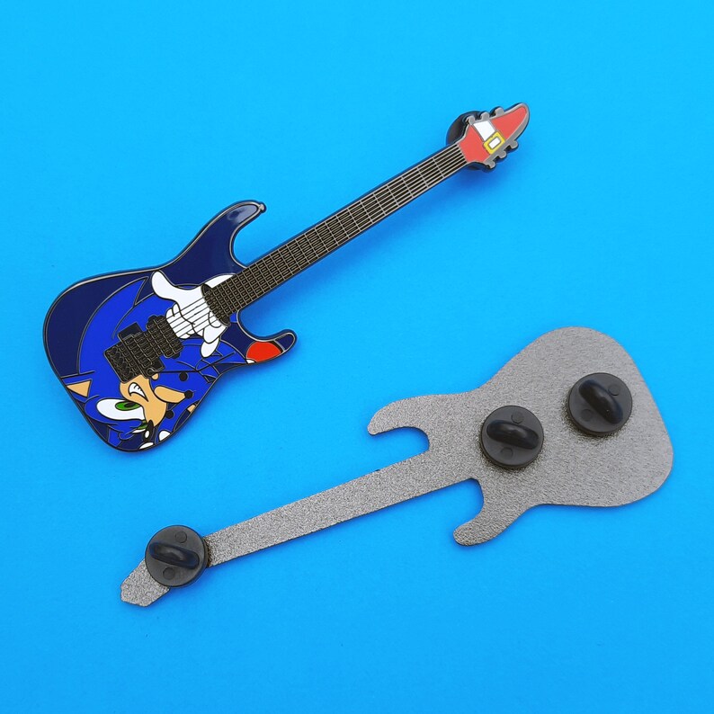 Image showing the front and back of the enamel pin badge based on the ESP Sonic-II guitar. Back side of the pin featured 3 pin posts with black rubber clutches.