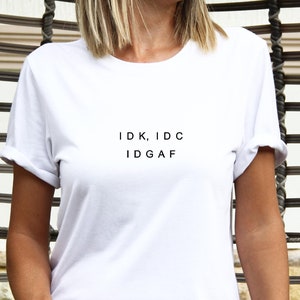 May include: A white t-shirt with the text "IDK, IDC IDGAF" printed on the front.
