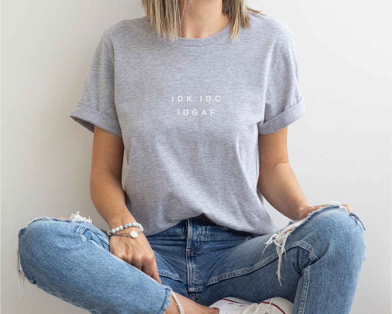 May include: A gray t-shirt with the text "IDK, IDC IDGAF" printed in white on the front.
