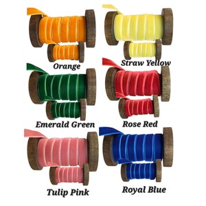May include: Six pairs of velvet ribbon spools in orange, straw yellow, emerald green, rose red, tulip pink, and royal blue. Each colour features one large and one small wooden spool wrapped with matching velvet ribbon, labelled with its colour name.