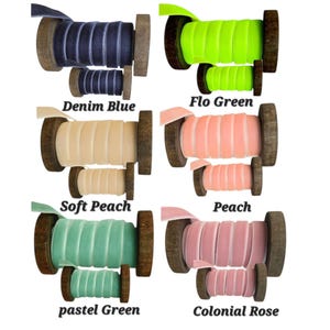 May include: Six pairs of velvet ribbon spools in denim blue, flo green, soft peach, peach, pastel green, and colonial rose. Each set includes one large and one small wooden spool wrapped with solid-coloured velvet ribbon, labelled with their respective colour names.