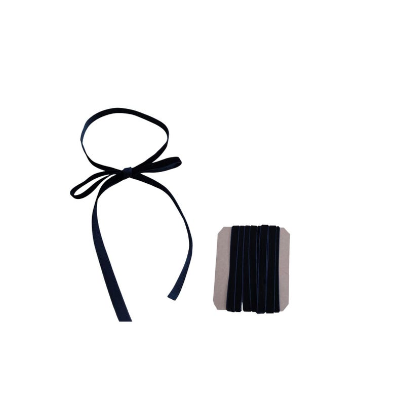 May include: A length of dark navy blue velvet ribbon tied into a bow and a matching spool of the same dark navy blue velvet ribbon wrapped around a rectangular cardboard card. The ribbon has a soft, textured surface and a deep, solid colour.