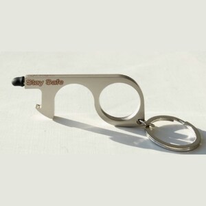 May include: Silver-toned keychain tool with a stylus tip, two loops for opening doors and a bottle opener. The tool has the words "Stay Safe" engraved on it.