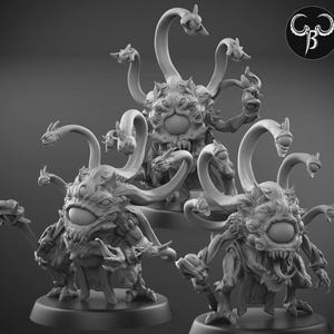 May include: Three detailed, gray fantasy miniatures of a multi-eyed monster with multiple tentacles and a large central eye. The creatures have a menacing appearance, with sharp teeth and claws, and are posed on circular bases.