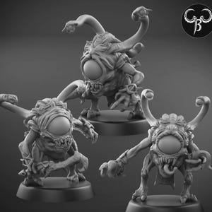 May include: Three detailed, gray miniature monster figurines with large central eyes, multiple tentacles, and menacing expressions. Each figure is mounted on a round base, showcasing a fantasy creature design.