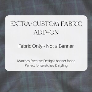 May include: A white rectangular label with rounded corners, featuring the text "EXTRA/CUSTOM FABRIC ADD-ON" and "Fabric Only - Not a Banner." The label is set against a plaid fabric background in shades of blue, green, and gray.